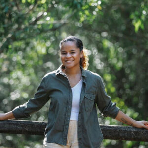 smiling woman leaning against railing